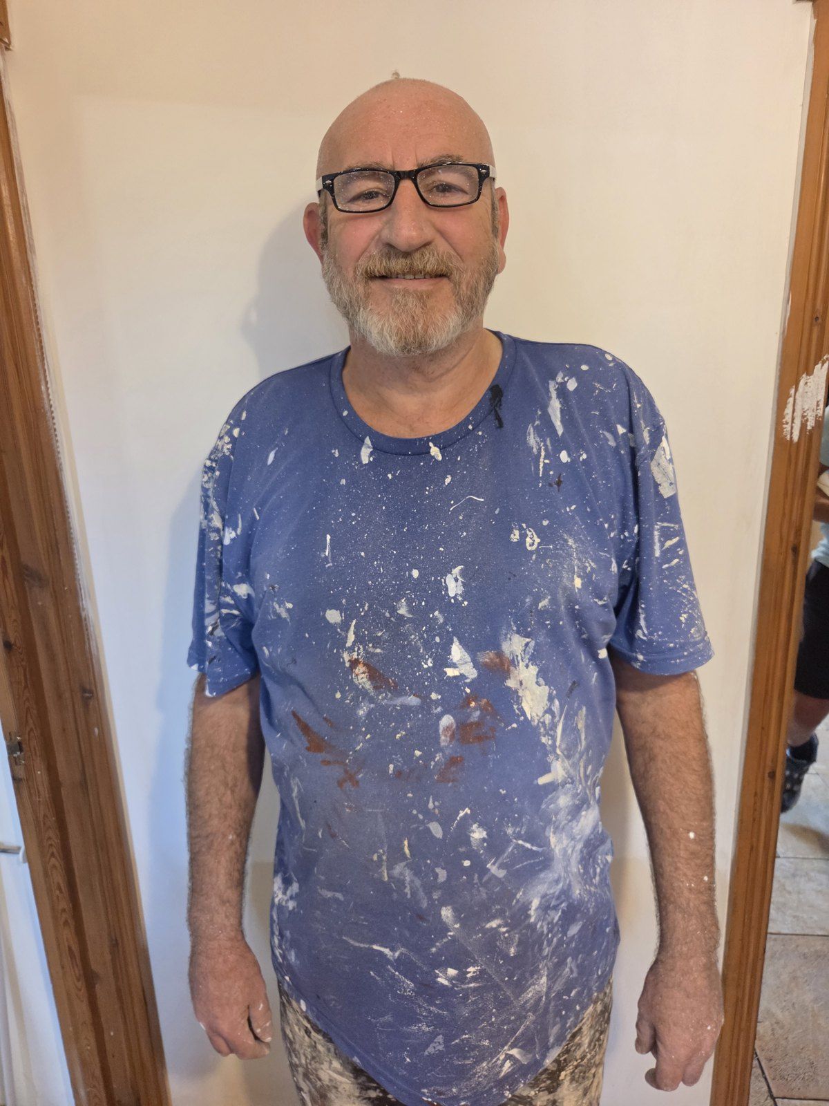 Chris Kelly in his paint-covered work clothes on a decorating job