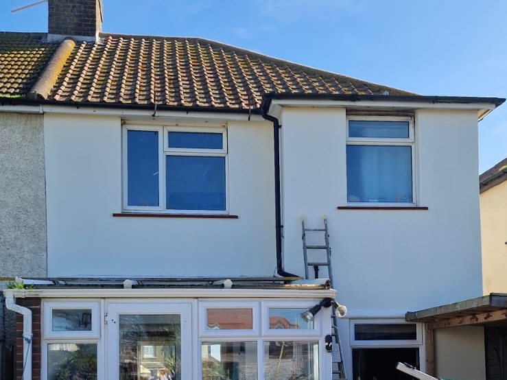 Rear of the same St Leonards house after exterior painting, with white walls and conservatory
